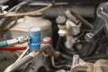 Servicing car air conditioner in repair workshop