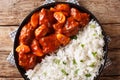 Serving of beef stew with apples in tomato sauce with rice side dish close-up on a plate. Horizontal top view Royalty Free Stock Photo