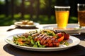 serving beer and grilled sausage to a plate with a sunny outdoor setting Royalty Free Stock Photo