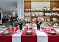 Serving of Bernardaud Limoges porcelain tableware on a table on a white tablecloth with red napkins Royalty Free Stock Photo