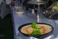 A serving bowl of hummus with chickpeas and olive oil on a buffet table Royalty Free Stock Photo