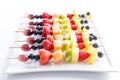 Serving of colorful fresh fruit kebabs