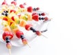 Serving of colorful healthy tropical fruit kebabs