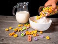 Serving colorful sugary cereal with milk in a bowl with cereal on the table Royalty Free Stock Photo