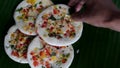 Serving colourful south Indian uttapam with coconut, green chili chutney