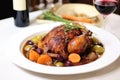 serving of coq au vin on a white plate