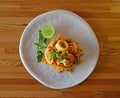 A serving of delicious Seafood Tom Yum Fried Rice on a round white plate