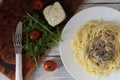 Serving dishes from pasta and mushrooms.