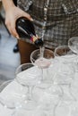 Woman in checkered skirt pours champagne into glasses