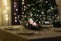 Serving the festive table. Food and drinks, plates and glasses. Evening lights and candles. Christmas dinner on Christmas Eve and Royalty Free Stock Photo