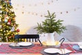 Serving a festive table with plates, forks, knives, napkins, glasses close-up in the modern interior of a loft house decorated for