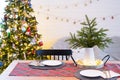 Serving a festive table with plates, forks, knives, napkins, glasses close-up in the modern interior of a loft house decorated for