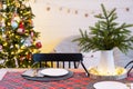 Serving a festive table with plates, forks, knives, napkins, glasses close-up in the modern interior of a loft house decorated for