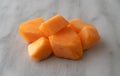 Serving of freshly cut cantaloupe on a marble counter top