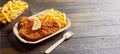 Serving of fried fish or schnitzel with fries