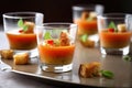 serving of gazpacho, garnished with croutons and olive oil drizzle