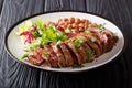 Serving grilled beef steak with fresh salad and beans close-up o Royalty Free Stock Photo