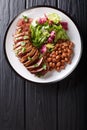 Serving grilled beef steak with fresh salad and beans close-up o Royalty Free Stock Photo