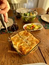 Serving Homemade Lasagna on Wooden Food Table at Home with Cozy Afternoon Natural Lights