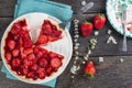 Serving homemade strawberry cake or pie on wooden table
