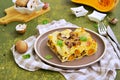 A serving of lasagna with pumpkin and mushrooms on ceramic plate on olive concrete background. Lasagna recipes. Pasta recipes