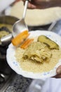 Serving a Moroccan couscous plate.