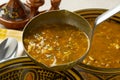 Serving Moroccan harira soup close up