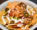 Serving of nachos with meat, cheese, white sauce and jalapenos Royalty Free Stock Photo