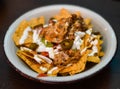 Serving of nachos with meat, cheese, white sauce and jalapenos Royalty Free Stock Photo