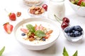 Ceramic granola bowl, assorted ingredients on table. Healthy nutritious breakfast with vegan yogurt, raw fruits, nuts and cereals. Royalty Free Stock Photo