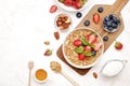 Ceramic granola bowl, assorted ingredients on table. Healthy nutritious breakfast with vegan yogurt, raw fruits, nuts and cereals. Royalty Free Stock Photo