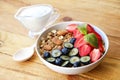 Ceramic granola bowl, assorted ingredients on table. Healthy nutritious breakfast with vegan yogurt, raw fruits, nuts and cereals. Royalty Free Stock Photo