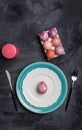 Serving plate for Easter and other holidays with stand for eggs and candle on black background. Free space for text