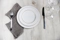 Serving plate, spoon, fork, knife and grey napkin Royalty Free Stock Photo