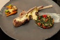 Serving rack of lamb on a plate. vegetable stew.  sauce Royalty Free Stock Photo