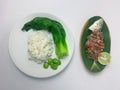 Serving rice, pakcoy boiled, bitter bean, and steamed fish yellowtail scad with matah chili sauce on a plate Royalty Free Stock Photo