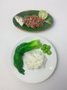 Serving rice, pakcoy boiled, bitter bean, and steamed fish yellowtail scad with matah chili sauce on a plate Royalty Free Stock Photo