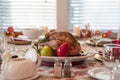 Serving roast turkey garnished with fresh herbs and fruit for traditional Thanksgiving dinner