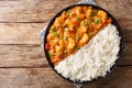 Serving of shrimp Etouffee with vegetables and sauce served with rice closeup in a plate. Horizontal top view Royalty Free Stock Photo