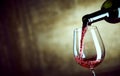 Serving a single glass of red wine from a bottle Royalty Free Stock Photo