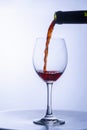 Serving a single glass of red wine from a bottle Royalty Free Stock Photo