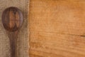 Serving spoons on burlap cloth on wooden surface