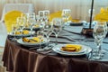 Serving table in restaurant with wine glasses and cutlery. Royalty Free Stock Photo