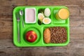 Serving tray with healthy food on wooden background. School lunch Royalty Free Stock Photo