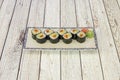 Serving tray of Norwegian salmon sushi with ripe avocado with Japanese rice, vinegar and sugar wrapped in nori seaweed