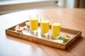 serving tray with small shot glasses of mango lassi for a tasting event Royalty Free Stock Photo