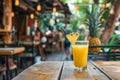 Serving a tropical pineapple cocktail on a charming wooden table at an inviting street side cafe