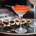 Serving try with oysters staffed with caviar and a glass of red caviar. Texture of red caviar. Luxury seafood and caviar tasting