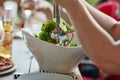 Serving up freshness. an unidentifiable young man serving salad at a dinner party with friends. Royalty Free Stock Photo