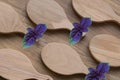 Serving wooden boards in drop shape with holes for hanging, diagonal pattern with purple-green basil sprigs. Abstract